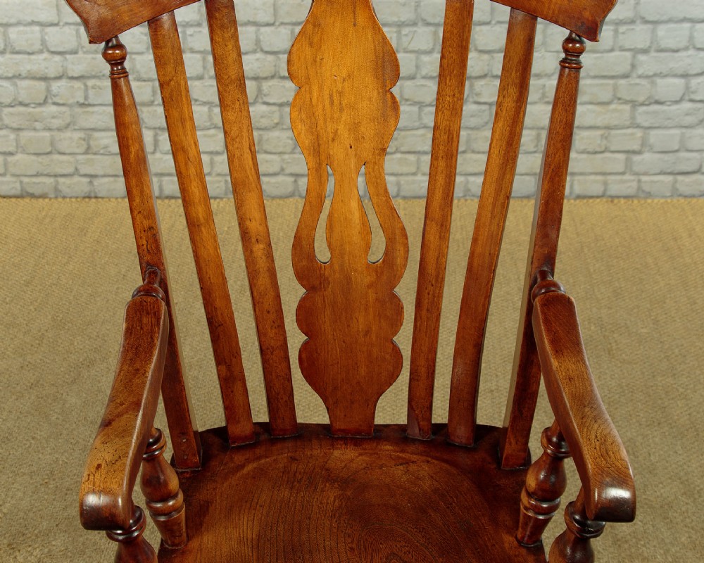 A Victorian highback wooden armchair featuring turned legs, curved armrests, a contoured seat, and a pierced back splat. View V