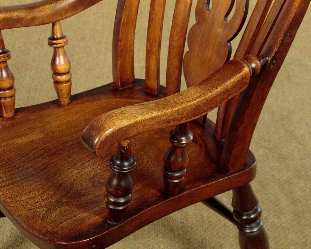 A Victorian highback wooden armchair featuring turned legs, curved armrests, a contoured seat, and a pierced back splat. View VIII