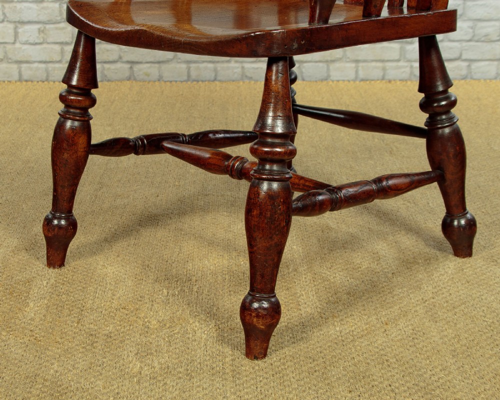 A Victorian highback wooden armchair featuring turned legs, curved armrests, a contoured seat, and a pierced back splat. View IX