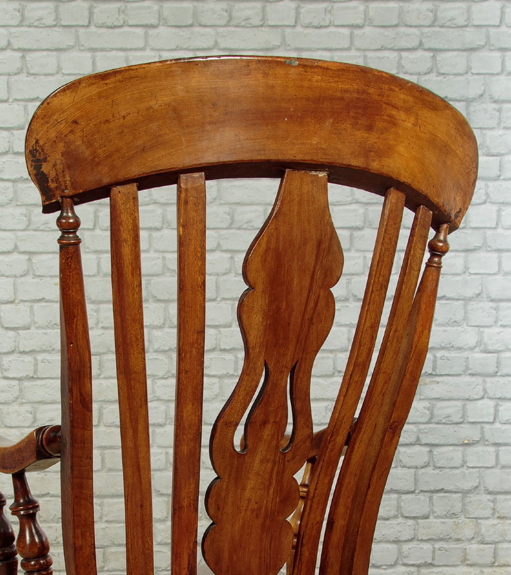 A Victorian highback wooden armchair featuring turned legs, curved armrests, a contoured seat, and a pierced back splat. View XI