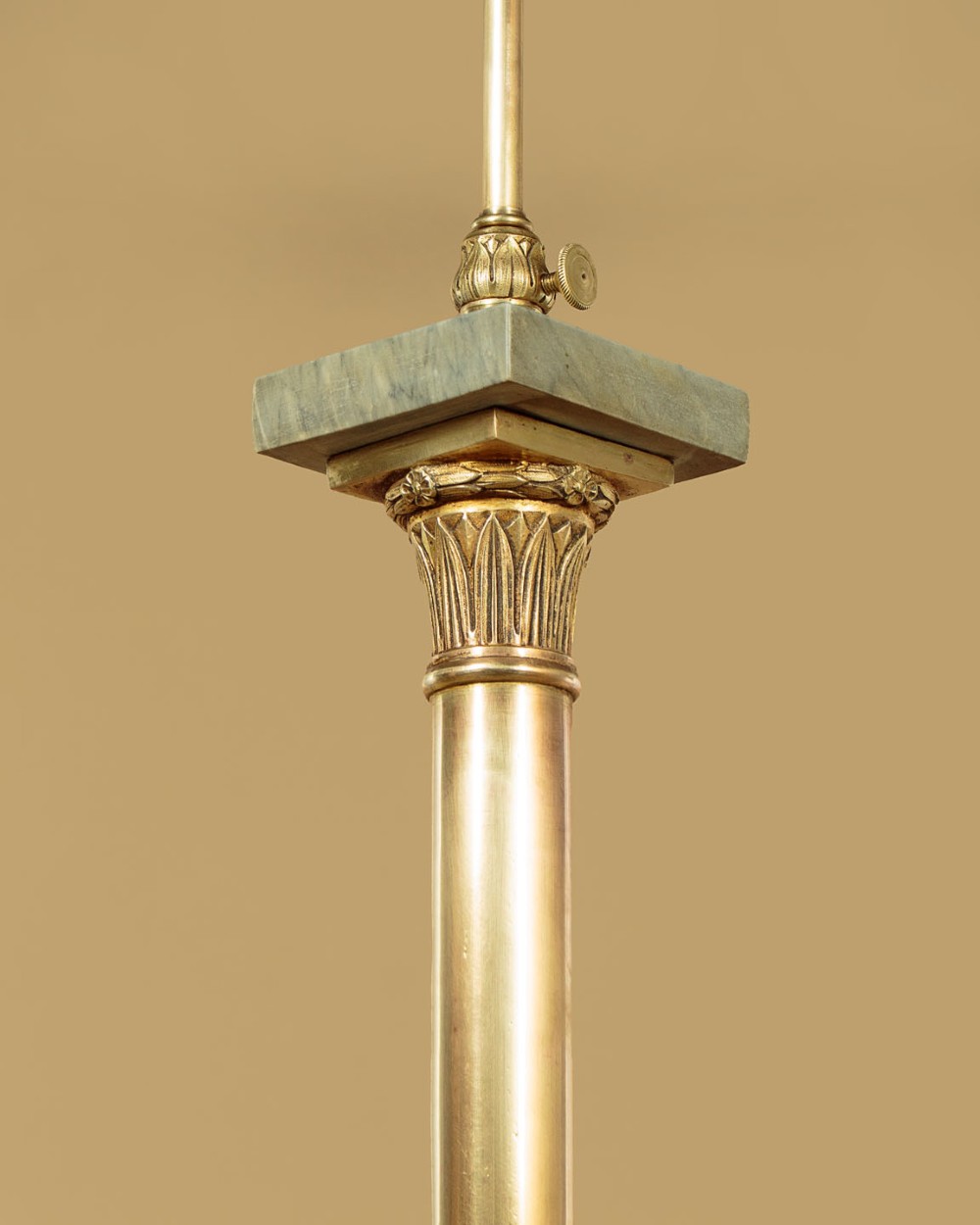 An adjustable French Empire style brass floor lamp featuring a fluted standard column set upon a grey marble base with brass claw feet. View V