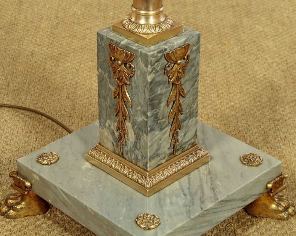 An adjustable French Empire style brass floor lamp featuring a fluted standard column set upon a grey marble base with brass claw feet. View VI