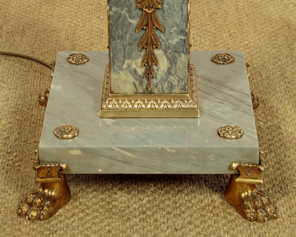 An adjustable French Empire style brass floor lamp featuring a fluted standard column set upon a grey marble base with brass claw feet. View VII