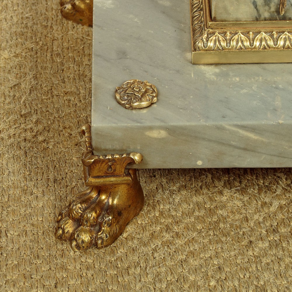 An adjustable French Empire style brass floor lamp featuring a fluted standard column set upon a grey marble base with brass claw feet. View VIII