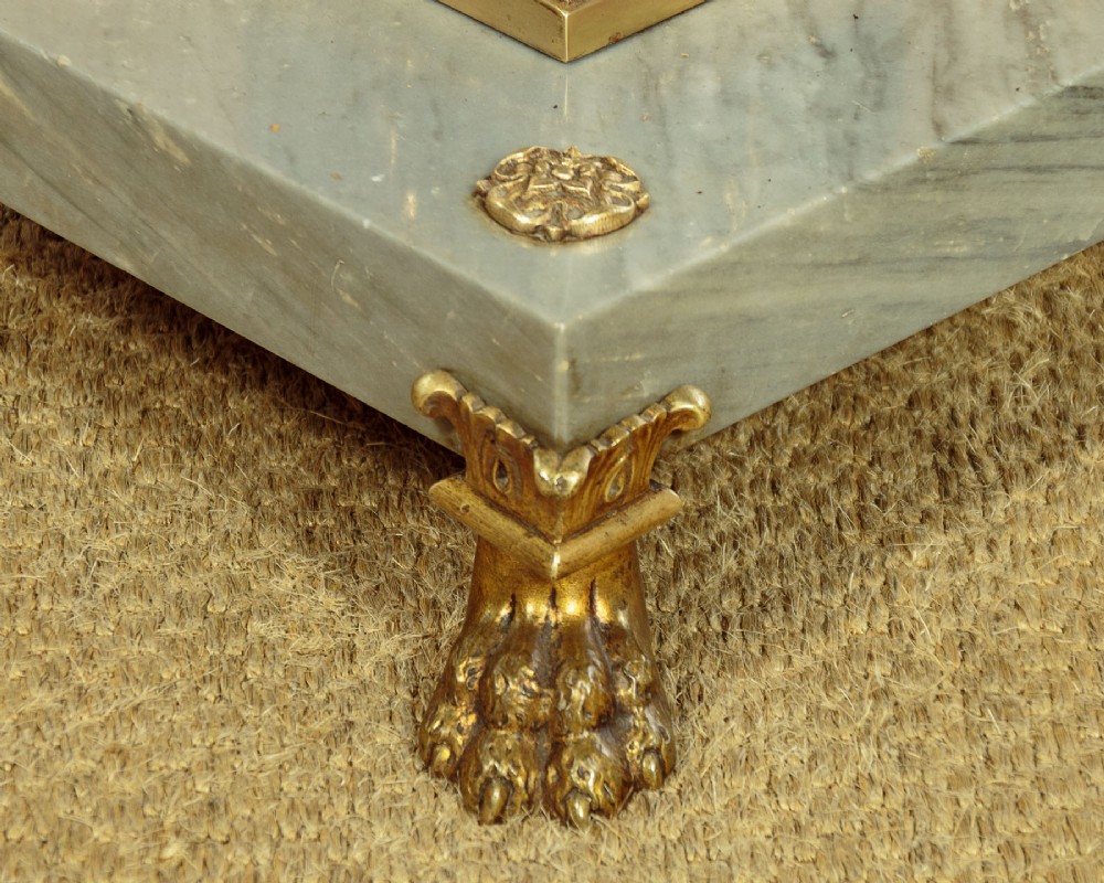 An adjustable French Empire style brass floor lamp featuring a fluted standard column set upon a grey marble base with brass claw feet. View IX