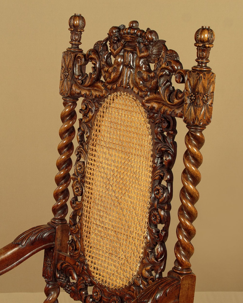 A pair of carved walnut armchairs featuring oval cane back panels, scroll armrests, and barley twist legs. View VIII