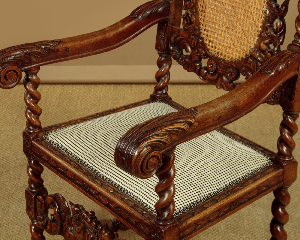 A pair of carved walnut armchairs featuring oval cane back panels, scroll armrests, and barley twist legs. View XI