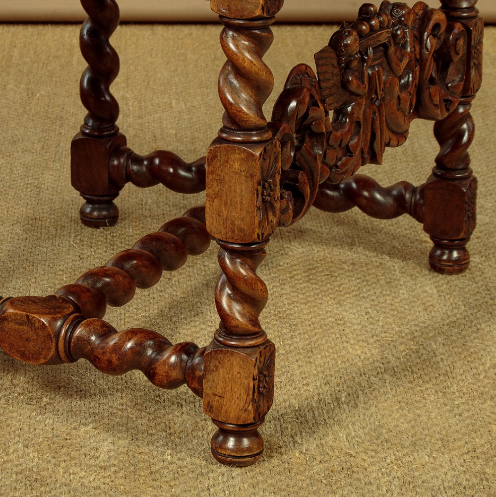 A pair of carved walnut armchairs featuring oval cane back panels, scroll armrests, and barley twist legs. View XV