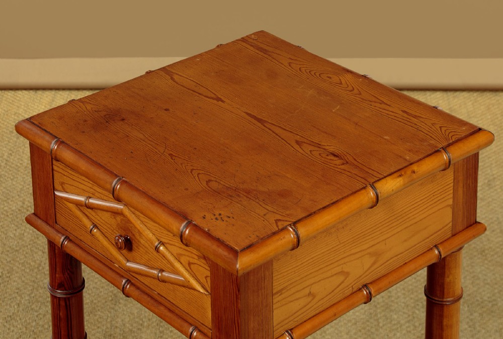 Late 19th-century faux bamboo wooden bedside cabinet featuring turned bamboo-style supports, an upper drawer with diamond moulding, an open shelf, and a lower drawer section. View V