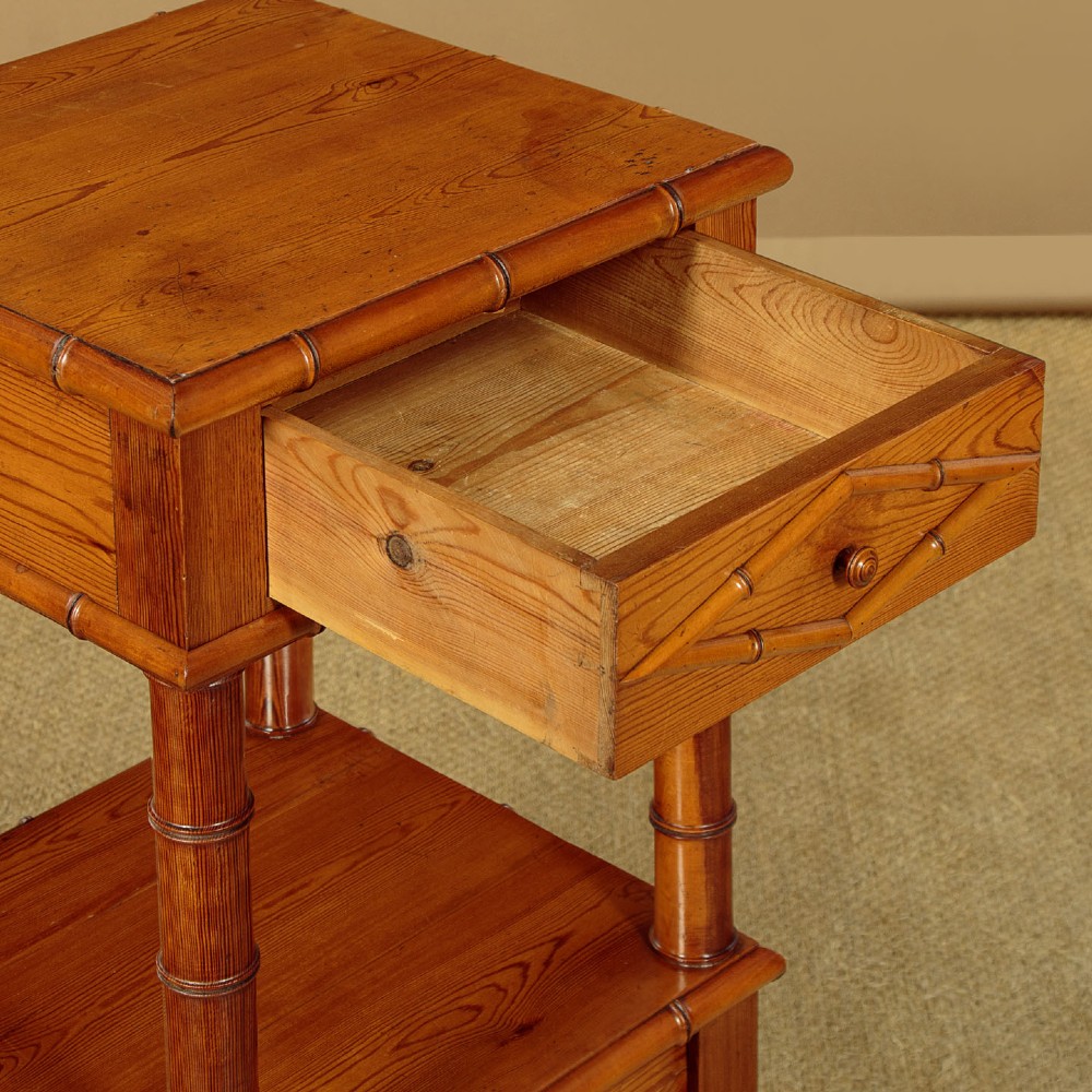 Late 19th-century faux bamboo wooden bedside cabinet featuring turned bamboo-style supports, an upper drawer with diamond moulding, an open shelf, and a lower drawer section. View VI