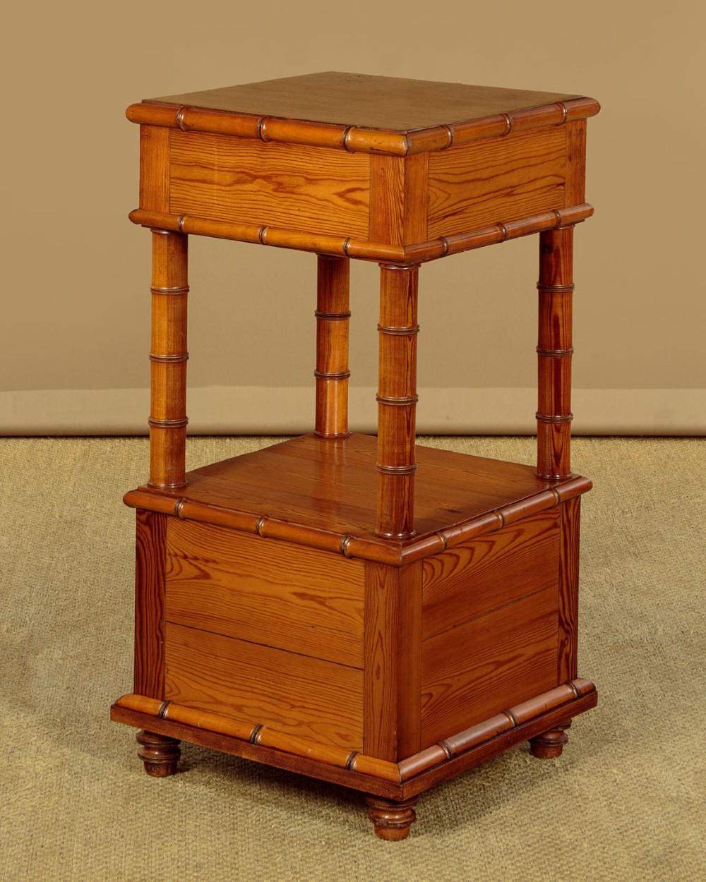 Late 19th-century faux bamboo wooden bedside cabinet featuring turned bamboo-style supports, an upper drawer with diamond moulding, an open shelf, and a lower drawer section. View XI