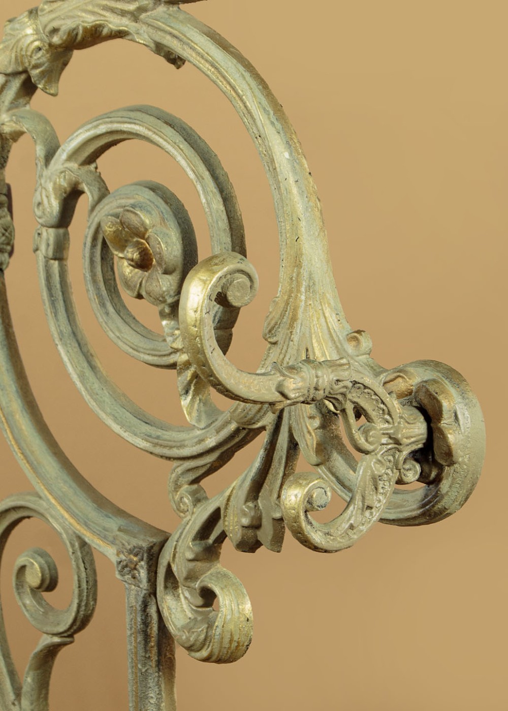 An ornate Victorian painted cast iron hall stand featuring scrollwork motifs, multiple coat hooks, a central oval mirror, and an umbrella drip tray base. View VIII