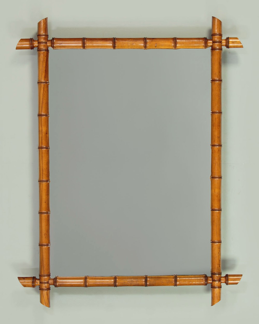 A late nineteenth-century rectangular wall mirror featuring a carved wooden frame that simulates natural bamboo with overlapping corner joints. View II