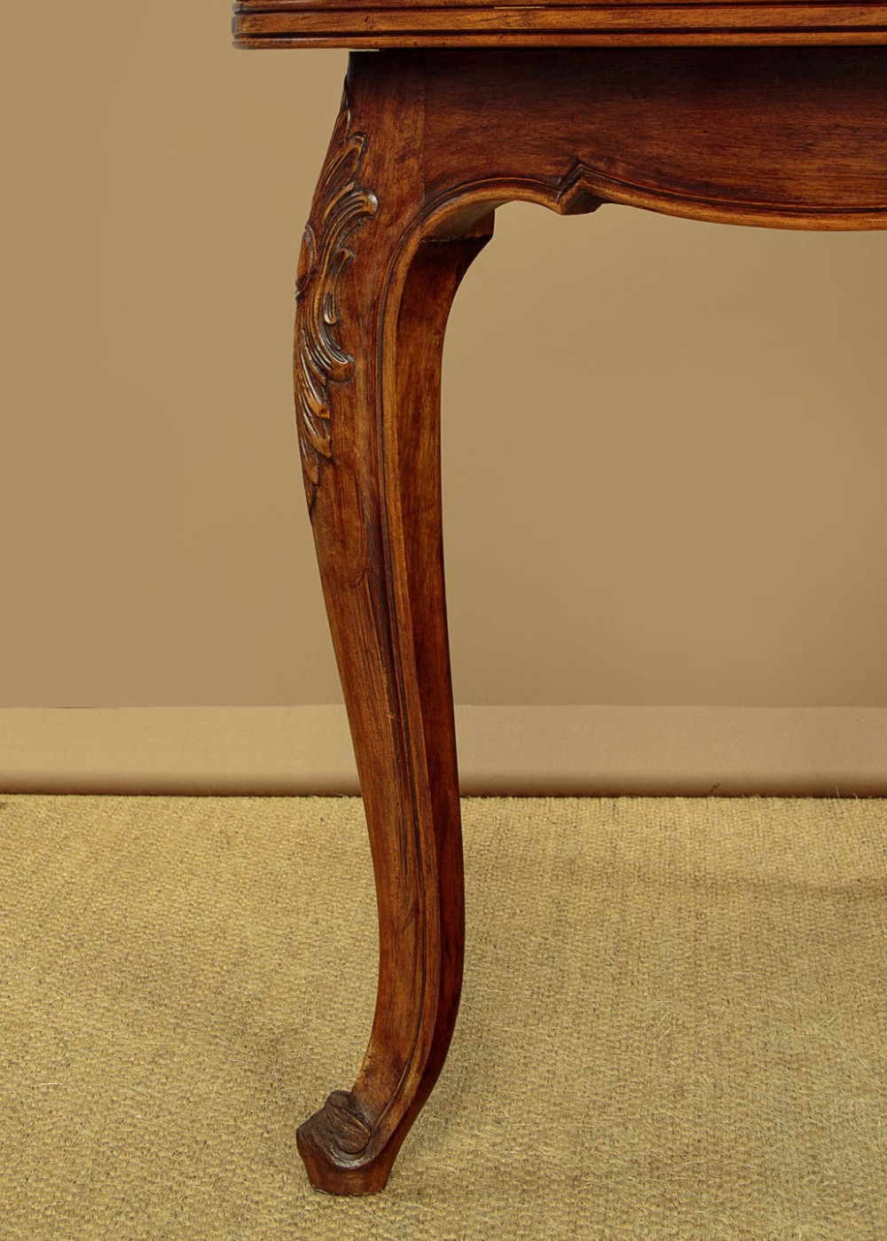 A rectangular French revival walnut dining table featuring a parquetry inlaid top, carved apron, and slender cabriole legs. View X
