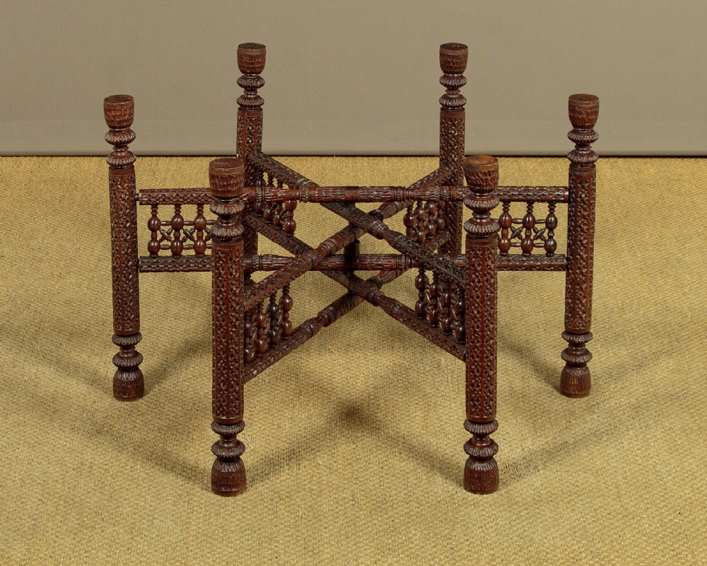 A large round brass tray table featuring detailed floral engravings supported on a dark carved hardwood base with turned legs. View XIII