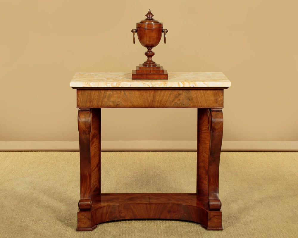 A late 19th-century mahogany console table featuring a light yellow marble top, S-scroll front supports with carved roundels, and a concave plinth base. View II