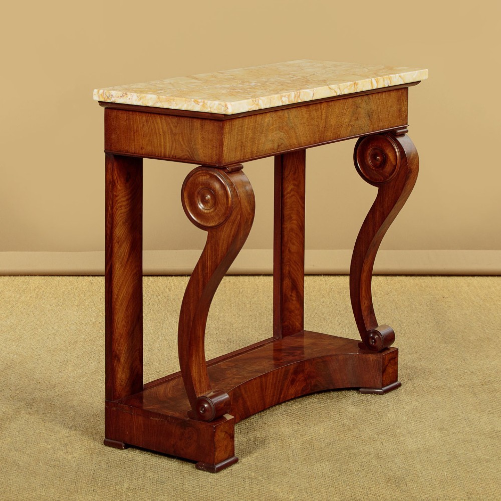 A late 19th-century mahogany console table featuring a light yellow marble top, S-scroll front supports with carved roundels, and a concave plinth base. View III