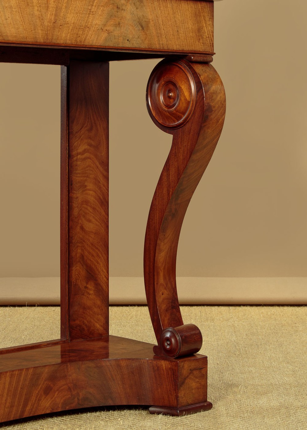A late 19th-century mahogany console table featuring a light yellow marble top, S-scroll front supports with carved roundels, and a concave plinth base. View VIII