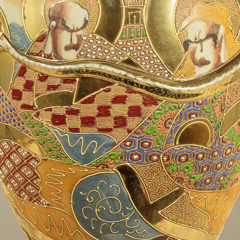 A pair of large Japanese Satsuma earthenware vases featuring hand-painted enamelled figures and high-relief gilded dragons wrapped around the necks. View X