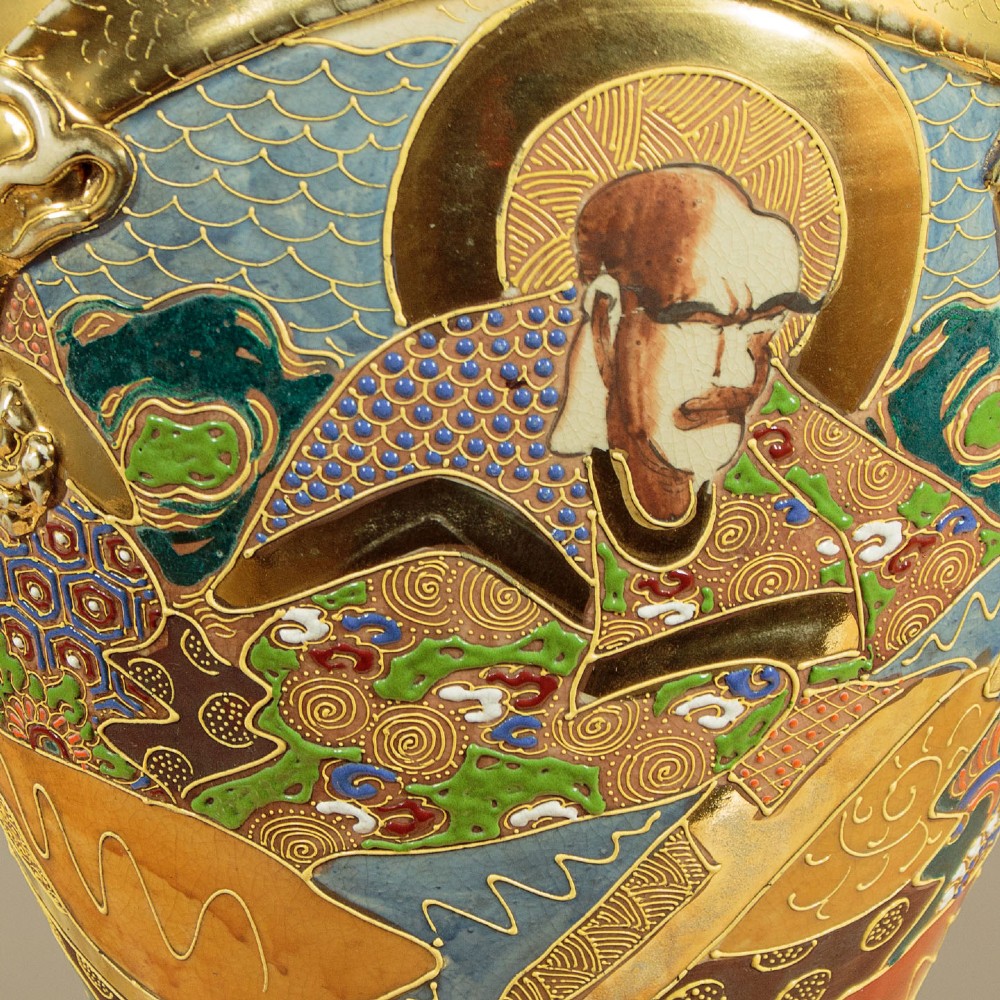 A pair of large Japanese Satsuma earthenware vases featuring hand-painted enamelled figures and high-relief gilded dragons wrapped around the necks. View XI