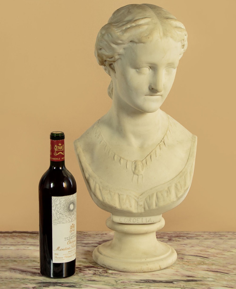 A carved off-white marble bust depicting the literary figure Cordelia set upon a turned pedestal base. View II