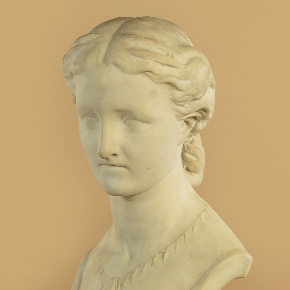 A carved off-white marble bust depicting the literary figure Cordelia set upon a turned pedestal base. View VII