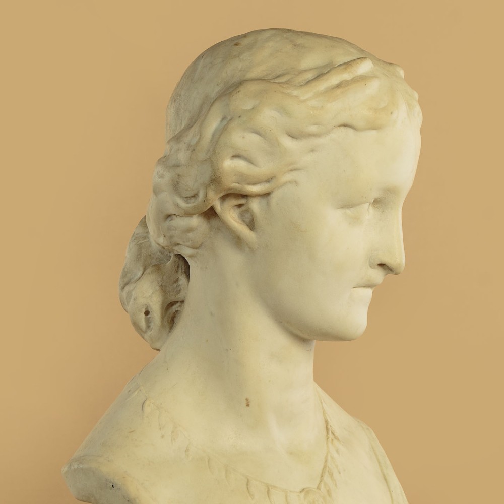 A carved off-white marble bust depicting the literary figure Cordelia set upon a turned pedestal base. View VIII