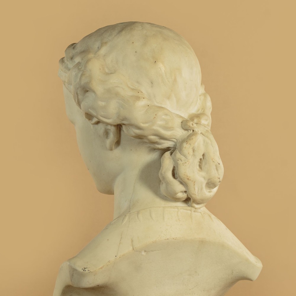 A carved off-white marble bust depicting the literary figure Cordelia set upon a turned pedestal base. View IX
