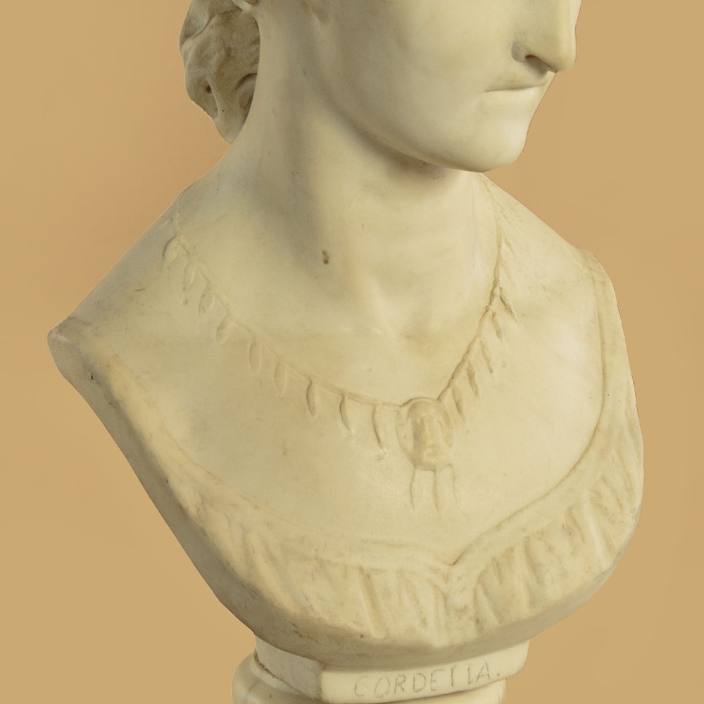 A carved off-white marble bust depicting the literary figure Cordelia set upon a turned pedestal base. View X