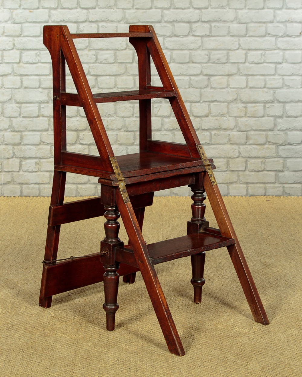 A late Victorian metamorphic mahogany side chair with turned front legs that folds open to convert into a short flight of library steps. View V