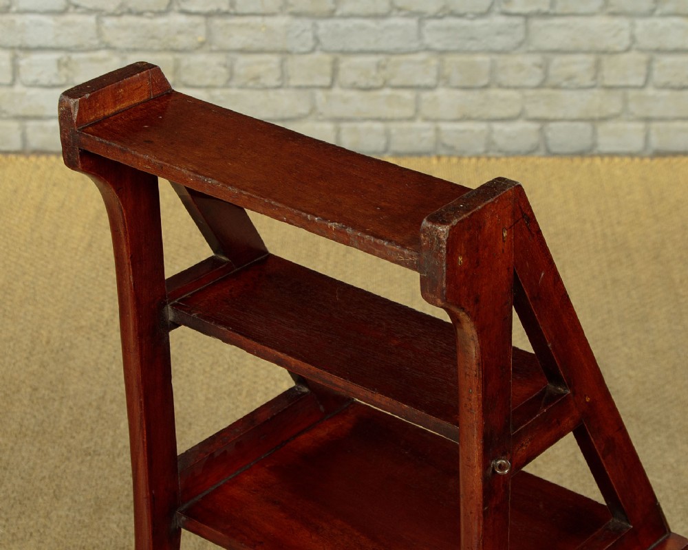 A late Victorian metamorphic mahogany side chair with turned front legs that folds open to convert into a short flight of library steps. View VI