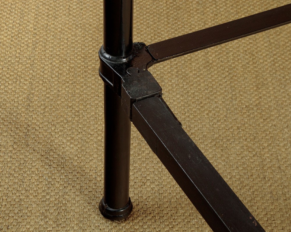 A late Victorian black iron and brass king-size bed frame featuring decorative brass finials, a dipped brass top rail, and vertical spindles. View X