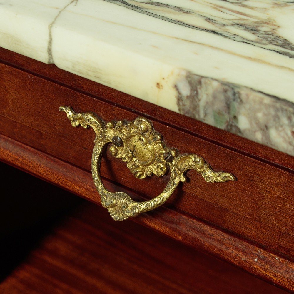 A pair of late 19th-century mahogany bedside cabinets featuring variegated marble tops, single upper drawers, open shelf recesses, and lower cupboards supported on cabriole legs. View VII