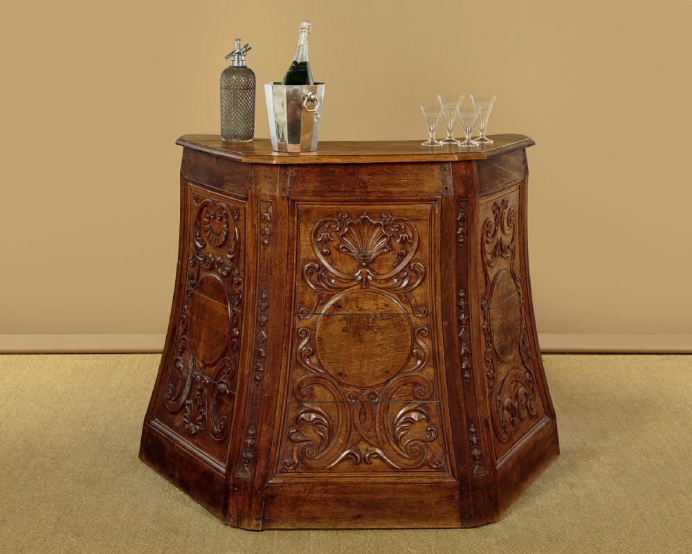A faceted dark oak pulpit bar featuring carved relief panels with shell motifs and scrollwork. View II
