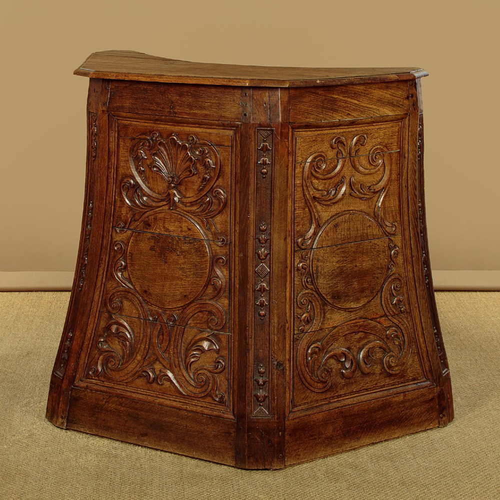 A faceted dark oak pulpit bar featuring carved relief panels with shell motifs and scrollwork. View IV