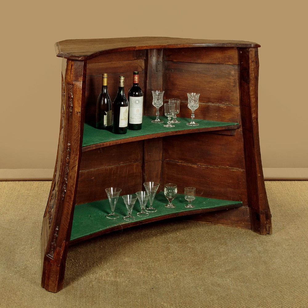 A faceted dark oak pulpit bar featuring carved relief panels with shell motifs and scrollwork. View V
