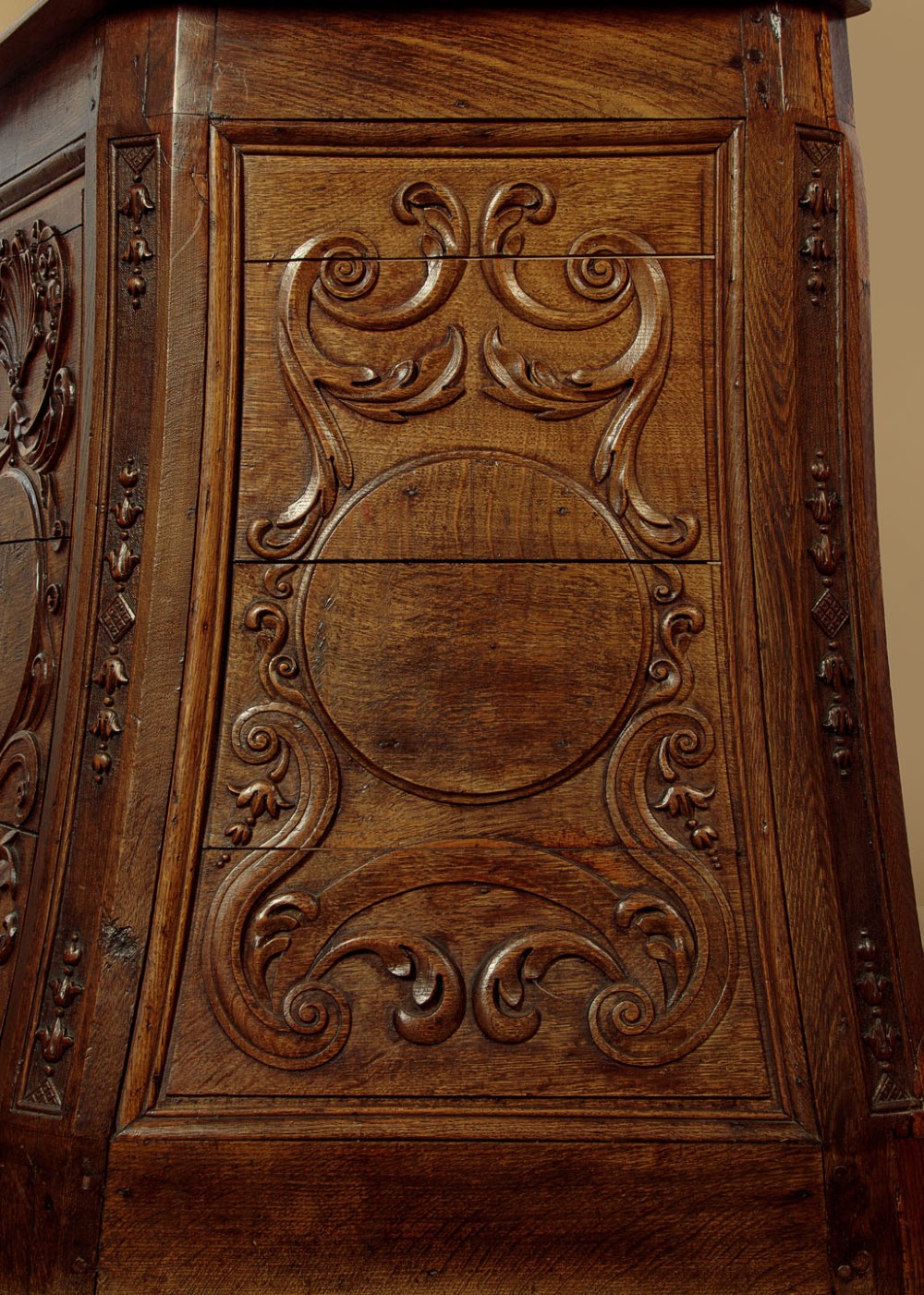 A faceted dark oak pulpit bar featuring carved relief panels with shell motifs and scrollwork. View IX