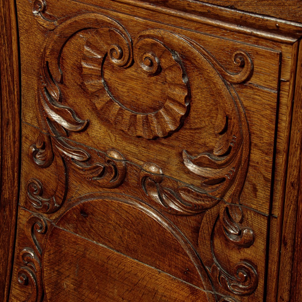 A faceted dark oak pulpit bar featuring carved relief panels with shell motifs and scrollwork. View XII