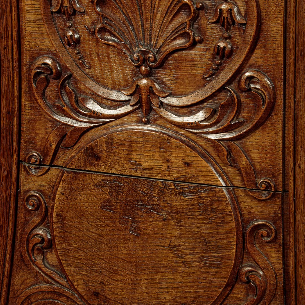 A faceted dark oak pulpit bar featuring carved relief panels with shell motifs and scrollwork. View XIII