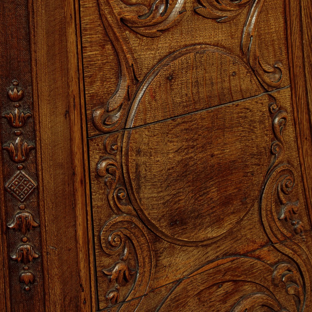 A faceted dark oak pulpit bar featuring carved relief panels with shell motifs and scrollwork. View XIV