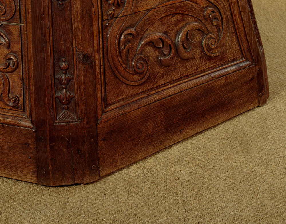 A faceted dark oak pulpit bar featuring carved relief panels with shell motifs and scrollwork. View XV