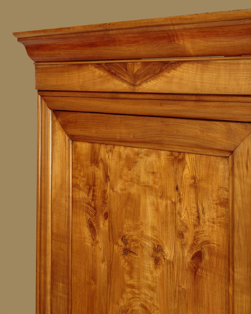 A single-door antique French Louis Philippe cherrywood wardrobe with figured timber grain and a moulded cornice. View V