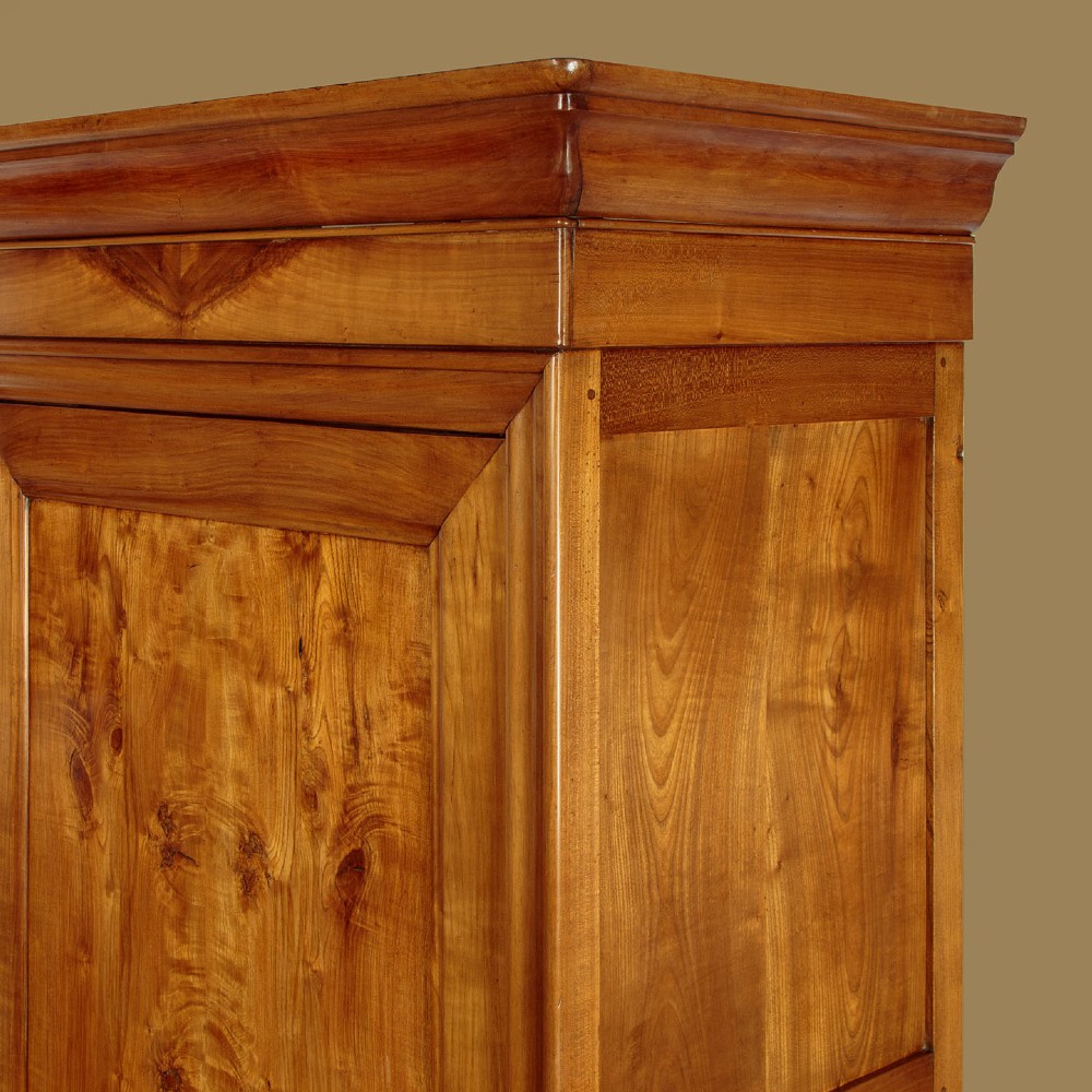 A single-door antique French Louis Philippe cherrywood wardrobe with figured timber grain and a moulded cornice. View VI
