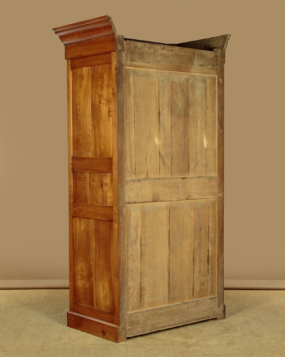 A single-door antique French Louis Philippe cherrywood wardrobe with figured timber grain and a moulded cornice. View XI
