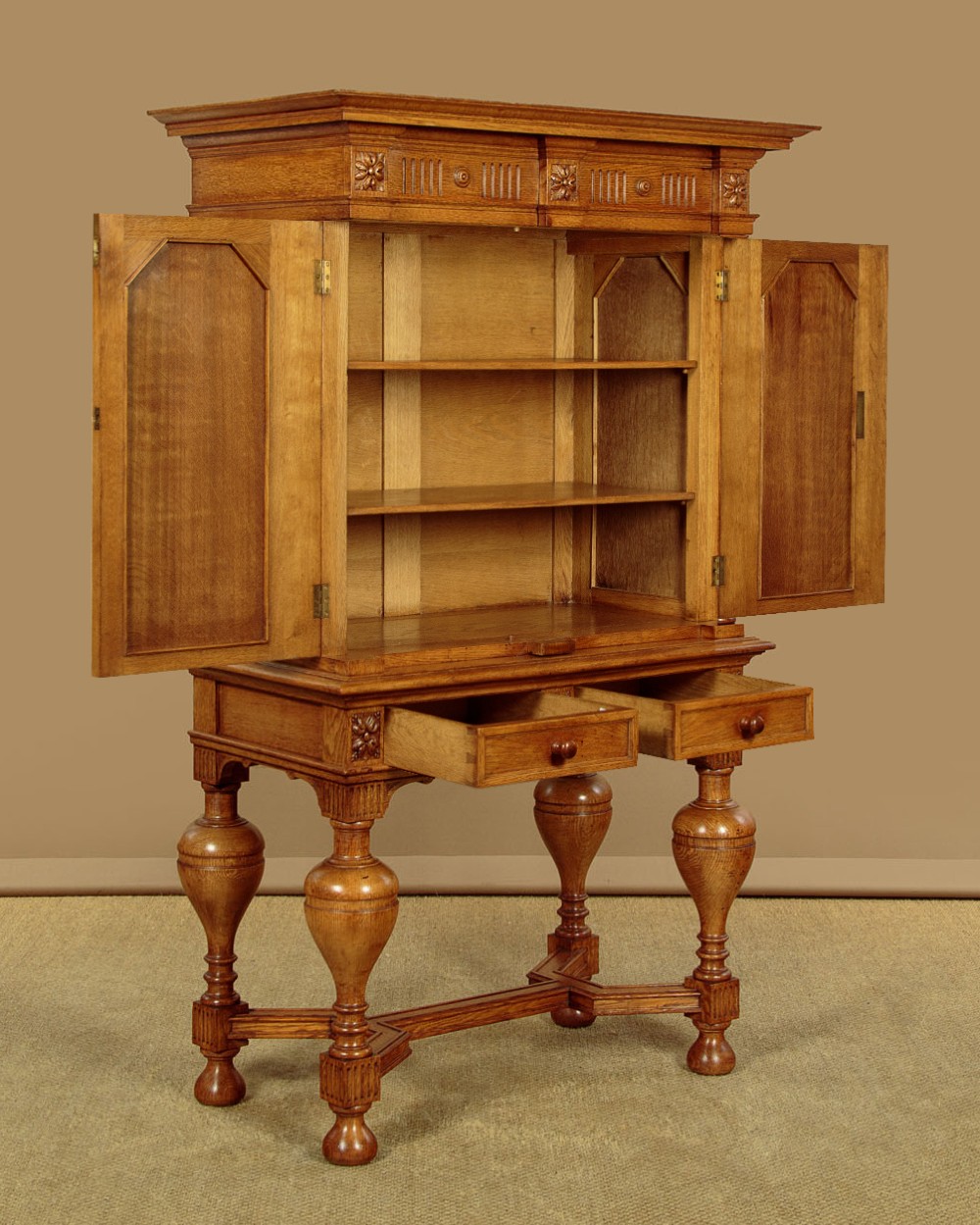 A warm brown oak cabinet featuring arched doors set upon a matching stand with large turned bulbous legs and lower stretchers. View IV