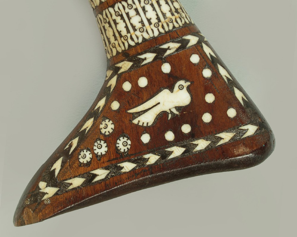 An antique Afghan Jezail musket featuring a distinctly curved wooden stock decorated with geometric bone inlay and a steel lock mechanism. View VIII