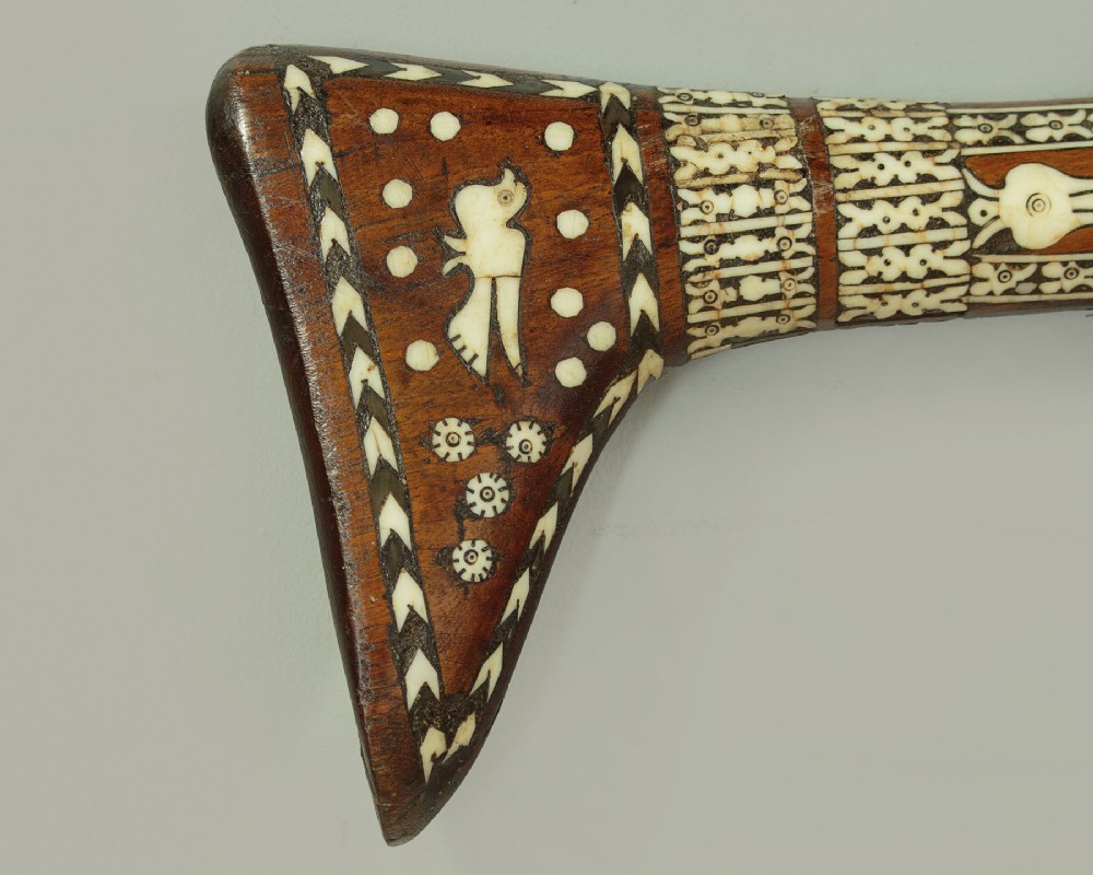 An antique Afghan Jezail musket featuring a distinctly curved wooden stock decorated with geometric bone inlay and a steel lock mechanism. View IX