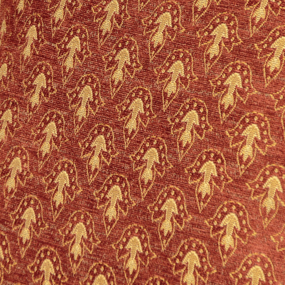 A c.1920 French-style upholstered day bed featuring a dark carved wooden frame, terracotta red patterned fabric, and matching tassel-trimmed cushions. View VIII