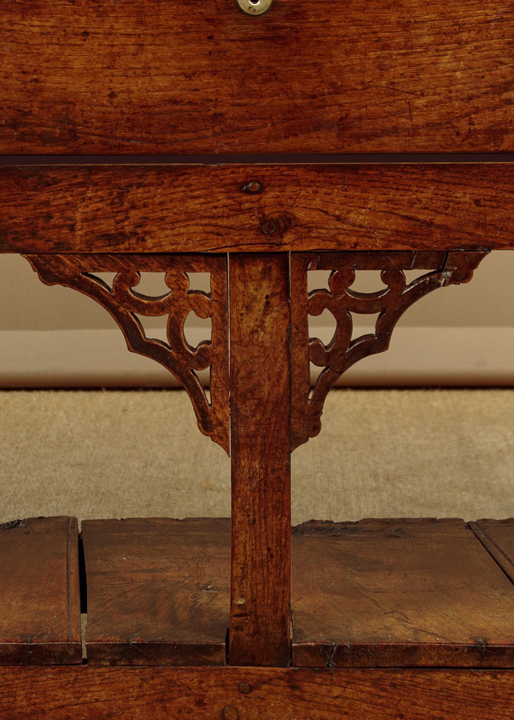 A eighteenth-century Georgian dark oak potboard dresser base featuring six drawer fronts with brass swan-neck handles and an open lower shelf. View X