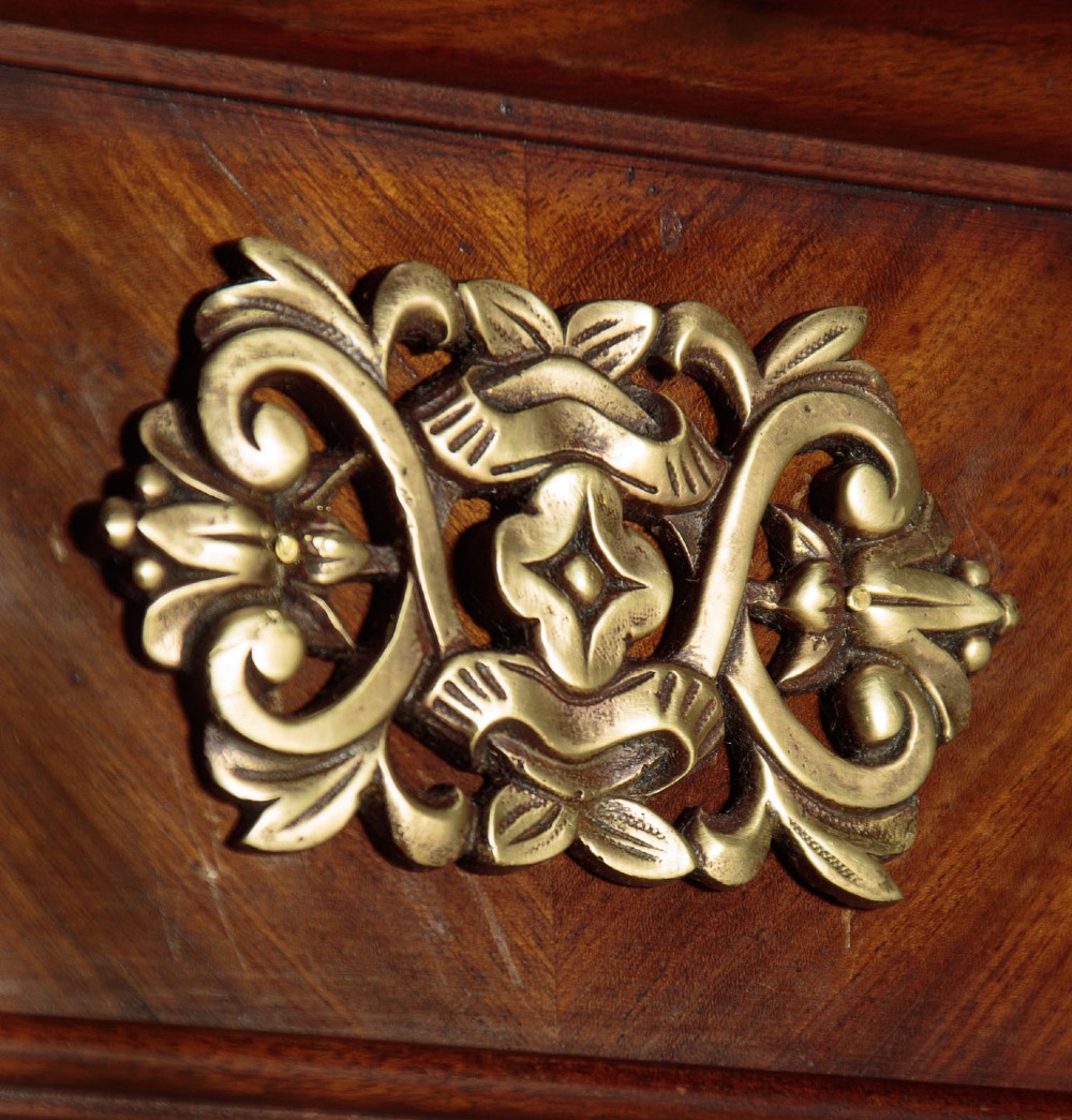 A mid-19th-century mahogany cheval mirror featuring a rectangular swivelling frame set between upright supports with an architectural corniced top and brass mount, resting on splayed feet with castors. View IV
